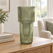 Satchville sage green tall ribbed glass vase on a sideboard, showcasing its elegant, textured design and slender shape.
