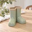 Large Satchville sage green ceramic Wellington boot vase displayed on a dining table