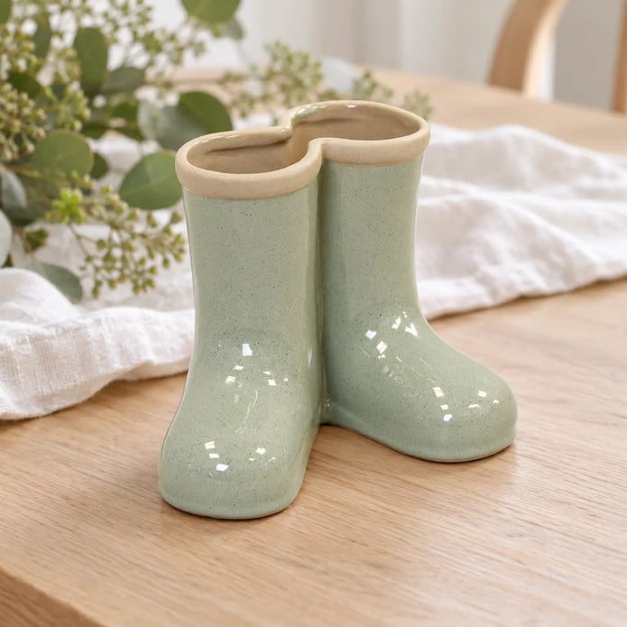 Satchville small sage green ceramic Wellington boot vase displayed on a dining table