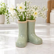 Satchville sage green ceramic Wellington boot vase with small flowers in a kitchen setting