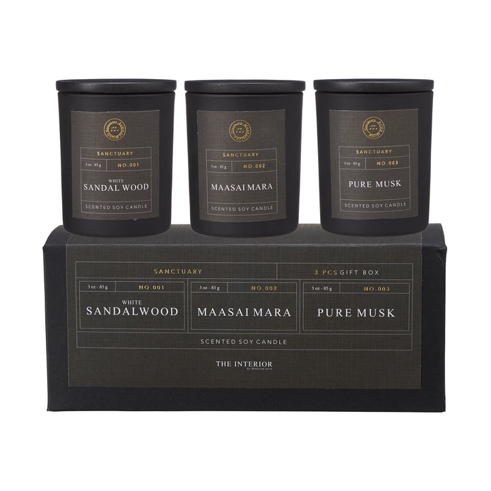 Sanctuary Candles Gift Set of Three in black jars above a gift box, labelled White Sandalwood, Maasai Mara and Pure Musk.