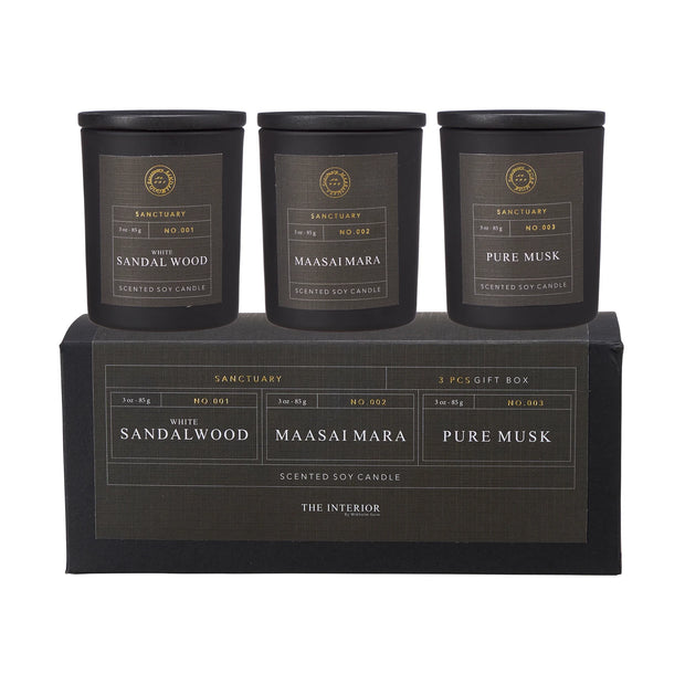 Sanctuary Candles Gift Set of Three in black jars above a gift box, labelled White Sandalwood, Maasai Mara and Pure Musk.