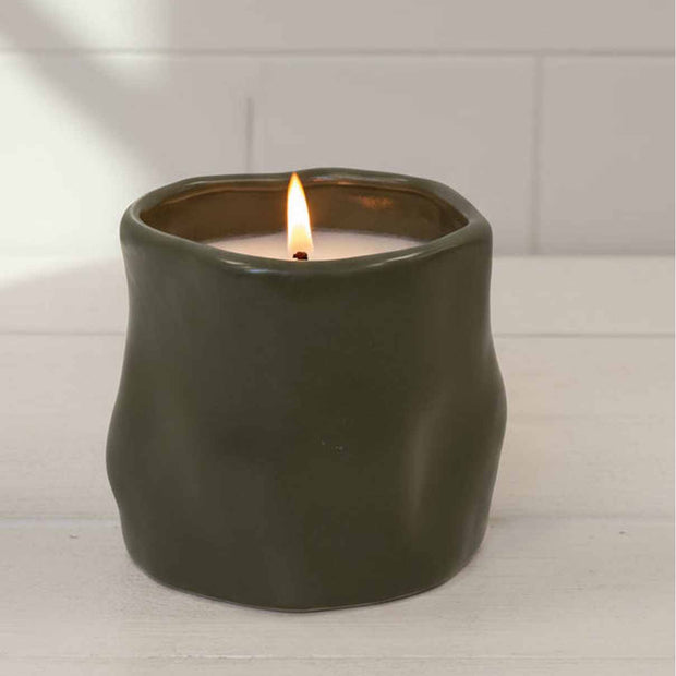 Olive green sculpted candle by Satchville, featured as a stylish home decor piece with intricate detailing.