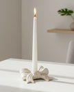 White ceramic bow-shaped dinner candle holder by Satchville, elegant home decor piece with a smooth glossy finish.