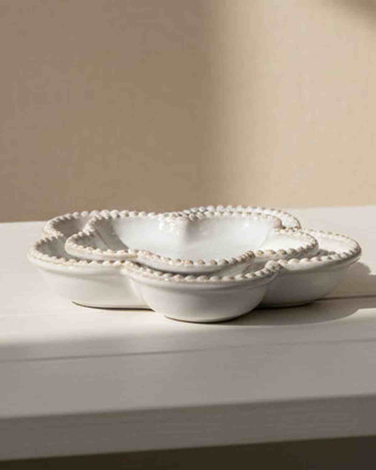 Natural ceramic flower-shaped plate with bobble rim, ideal for home decor, by Satchville, showcasing intricate design and craftsmanship.