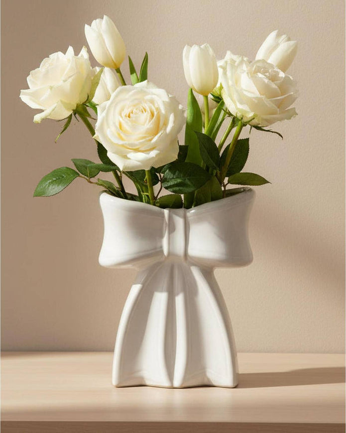 Small white ceramic bow vase by Satchville, perfect for home decor, featuring a smooth glossy finish and elegant bow shape.