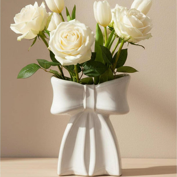 Small white ceramic bow vase by Satchville, perfect for home decor, featuring a smooth glossy finish and elegant bow shape.