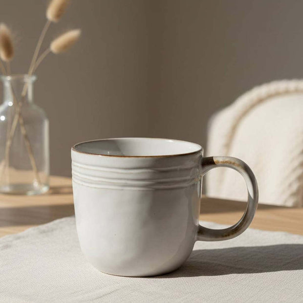 Natural ceramic mug by Satchville, showcasing a smooth, glazed finish and classic design for kitchen and dining use.