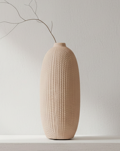 Tall beige textured stone vase by Satchville with a sleek, cylindrical shape and natural stone finish.