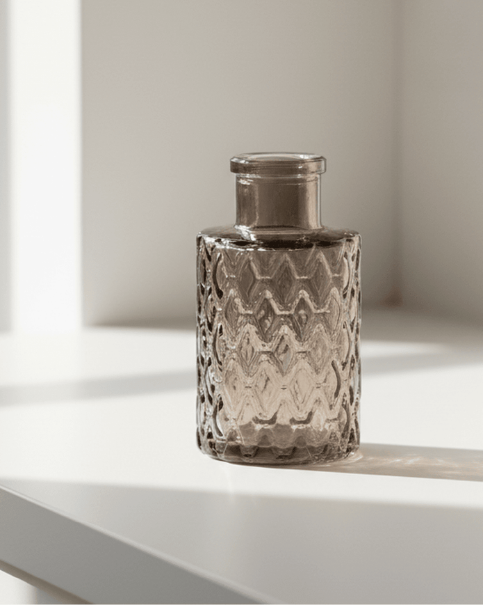 Warm grey glass mini bottle bud vase by Satchville, featuring a compact, elegant design perfect for small floral arrangements.