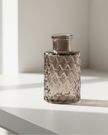 Warm grey glass mini bottle bud vase by Satchville, featuring a compact, elegant design perfect for small floral arrangements.