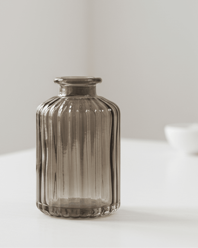 Warm grey glass tall bud vase by Satchville, featuring a sleek, cylindrical design perfect for floral arrangements.