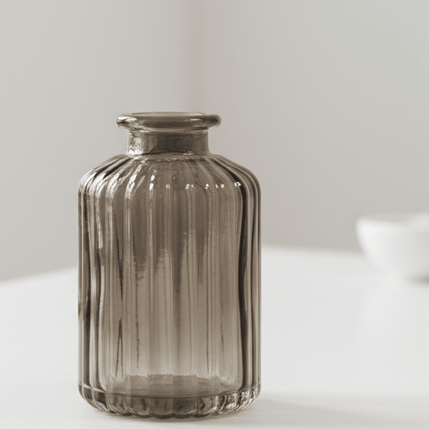 Warm grey glass tall bud vase by Satchville, featuring a sleek, cylindrical design perfect for floral arrangements.
