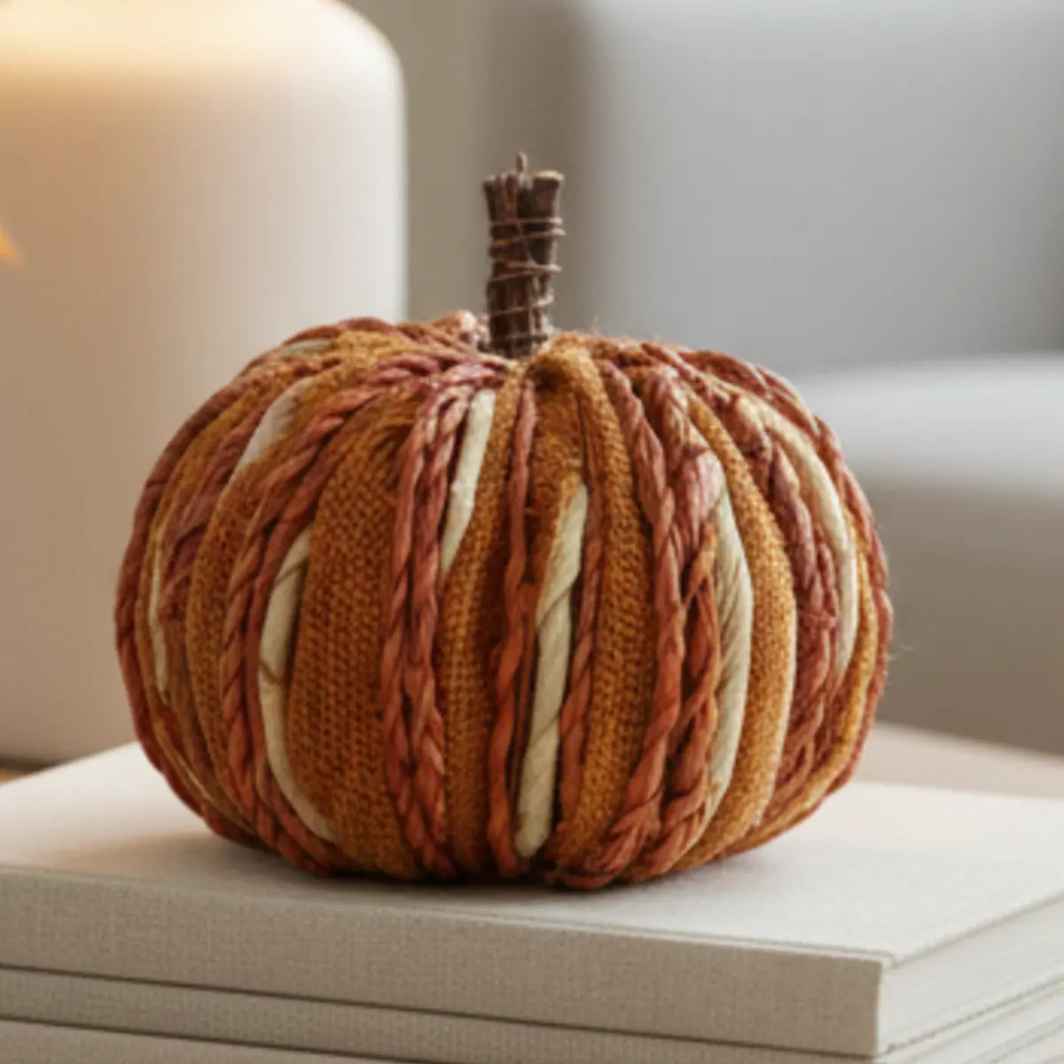Handcrafted orange plaited and dried grass pumpkin for autumn decor by Heaven Sends, with detailed woven texture.
