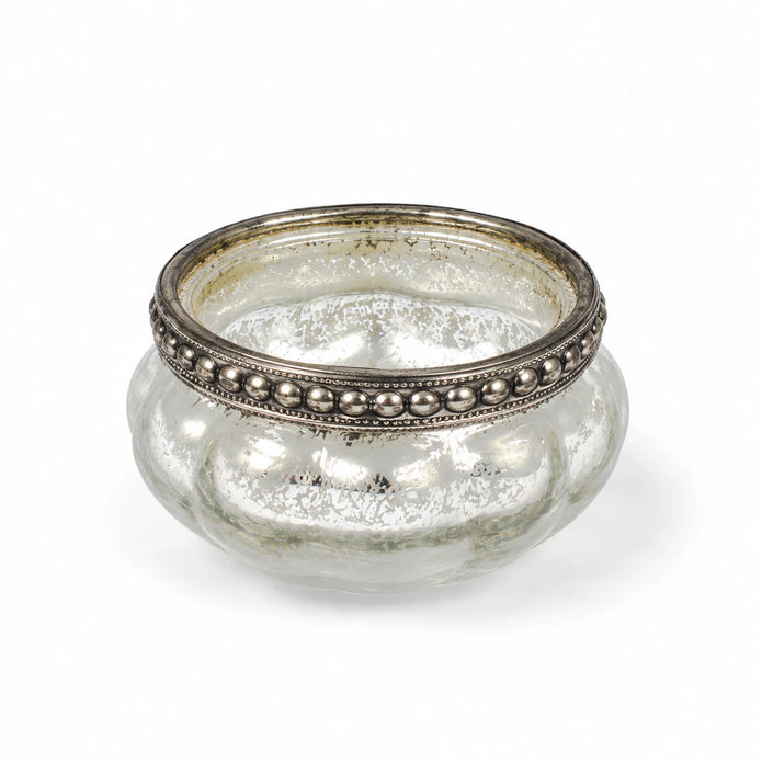 One empty silver glass tealight holder photographed on white.