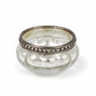 One empty silver glass tealight holder photographed on white.