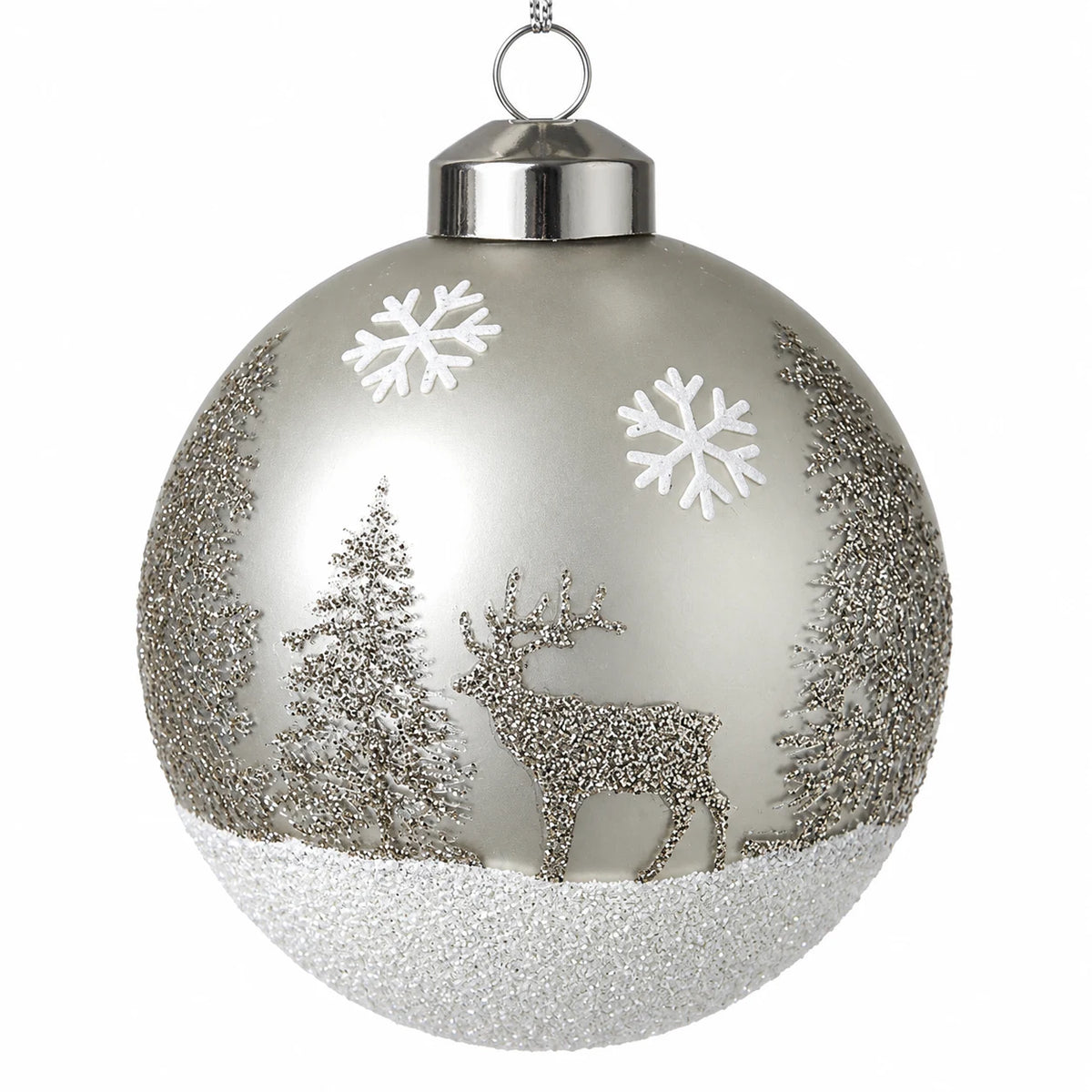 Detailed studio view of silver glitter stag, fir trees and white snowflakes on a glass bauble