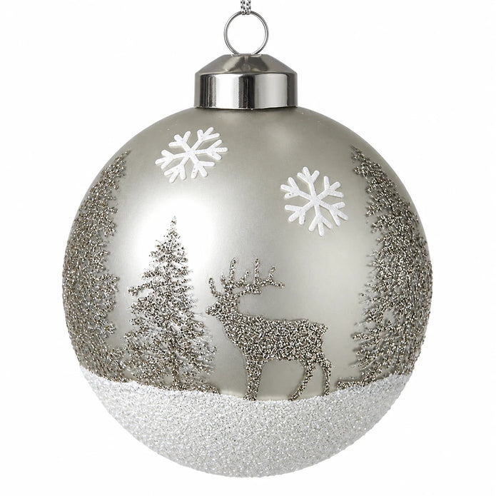 Detailed studio view of silver glitter stag, fir trees and white snowflakes on a glass bauble