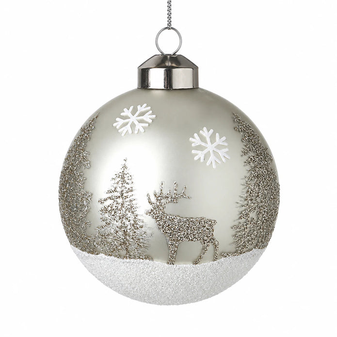 Silver glass winter scene bauble with glitter stag and fir trees on a white background
