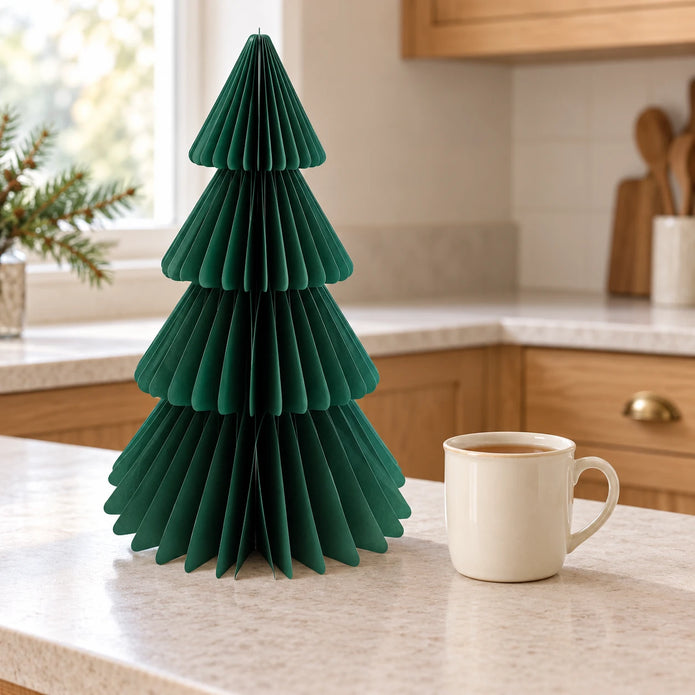 36cm green paper tree beside a mug of tea on a kitchen counter.