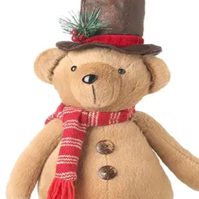 Close-up of Christmas teddy bear brown top hat, red striped scarf and plush fabric