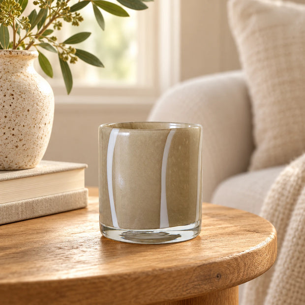 Small Beige Glass Tealight Holder — vertical white stripe design empty on oak side table