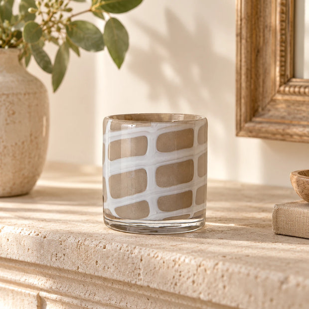 Small Beige Glass Tealight Holder — white irregular grid design empty on pale stone mantel