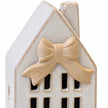 Close-up of the sculpted beige ceramic bow beneath the house roof.