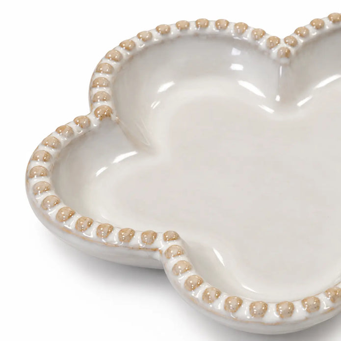 Close-up of the flower plate's raised bobble rim and cream glaze with natural tan accents