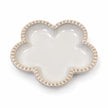 Small ceramic flower-shaped plate with bobble rim isolated on a white background