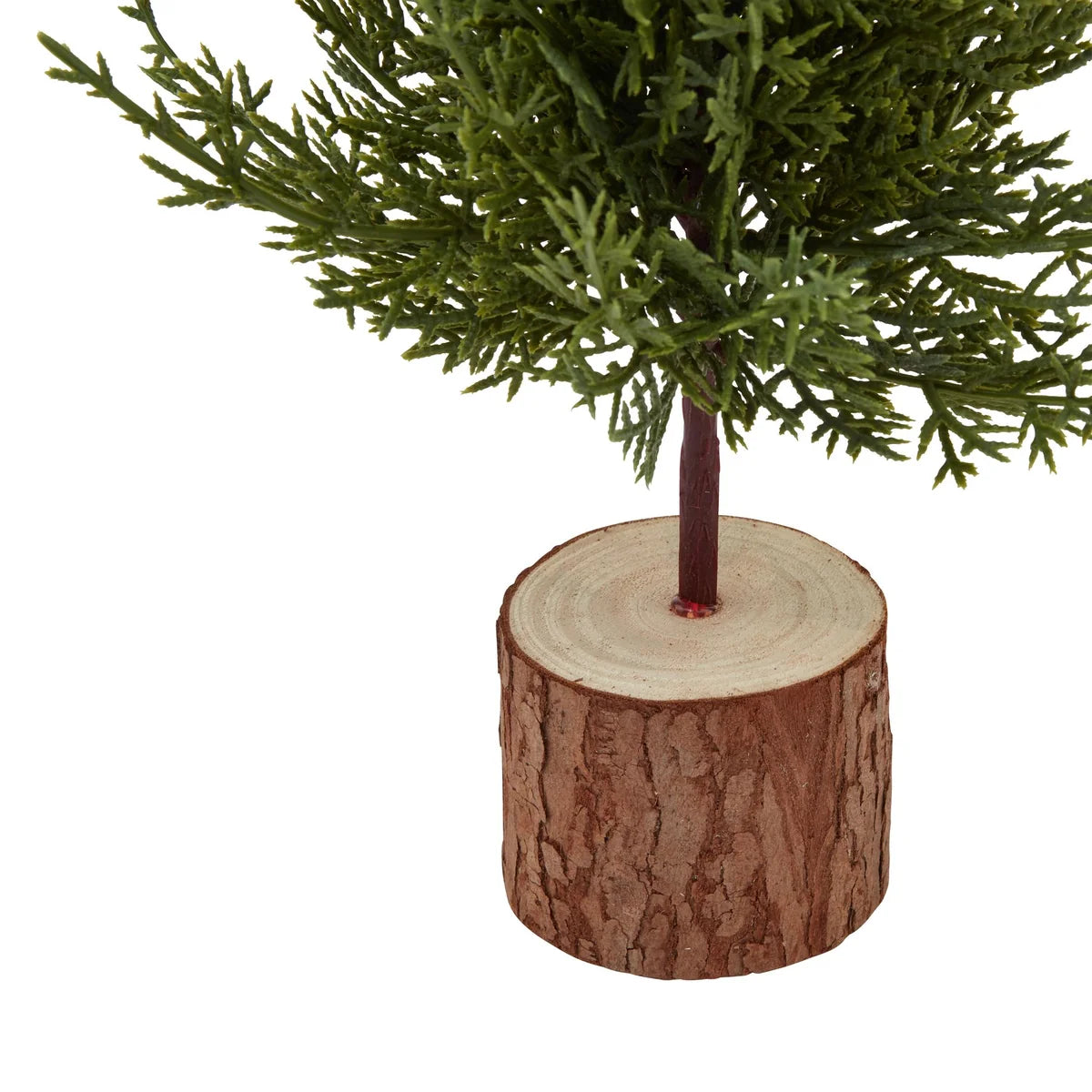 Close-up of natural wooden log base and narrow green fir branches on Small Green Fir Tree decoration