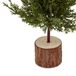 Close-up of natural wooden log base and narrow green fir branches on Small Green Fir Tree decoration