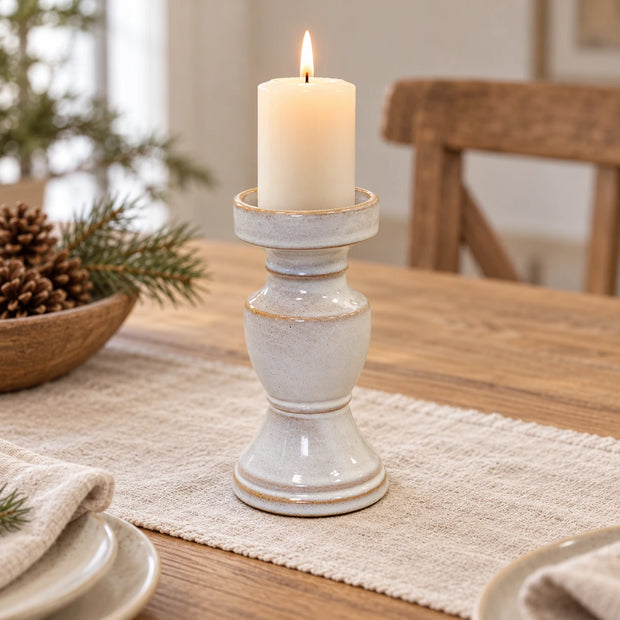 Small natural ceramic candle holder from Satchville, featuring a smooth, earthy finish and a hollow center for candles.