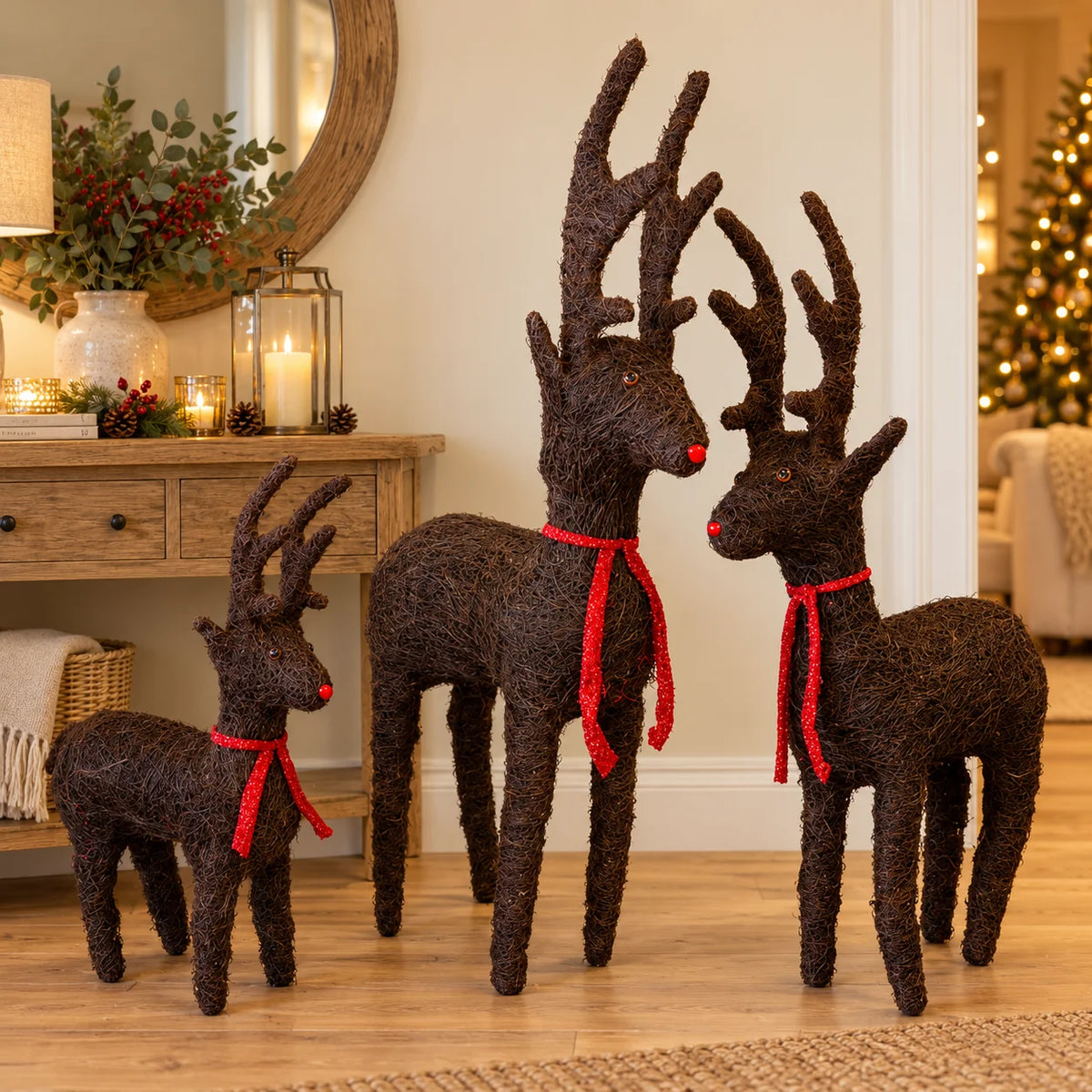 Standing brown Salim deer decorations with red ribbons in three sizes