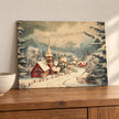 Unframed Snowy Village canvas board leaning on a darker oak sideboard.