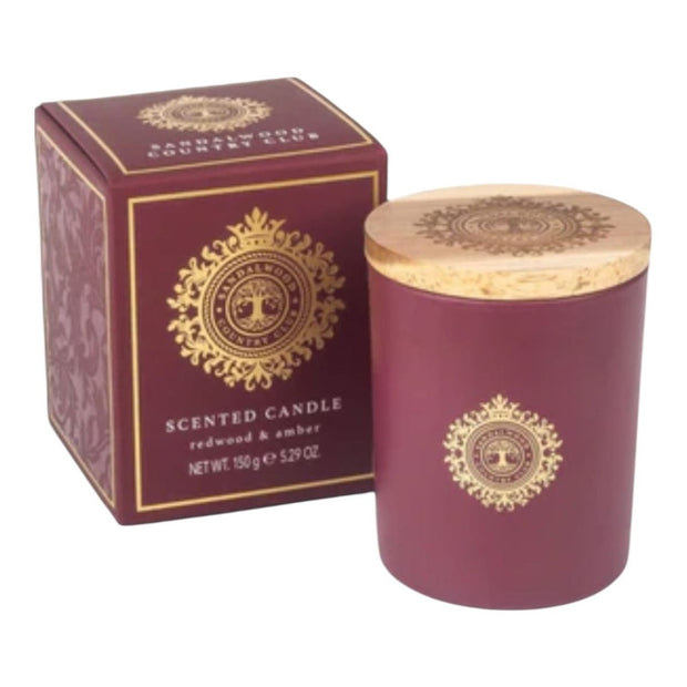Sandalwood Country Club Burgundy Candle by Somerset Toiletries featuring redwood and amber scents, in a decorative glass container.