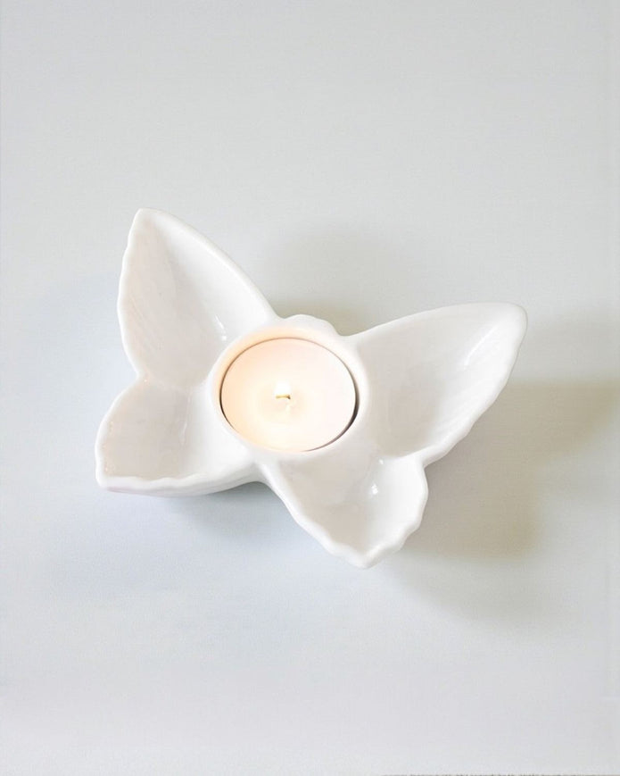 White butterfly tealight holder, decorative home decor piece with intricate butterfly design, perfect for ambient lighting.