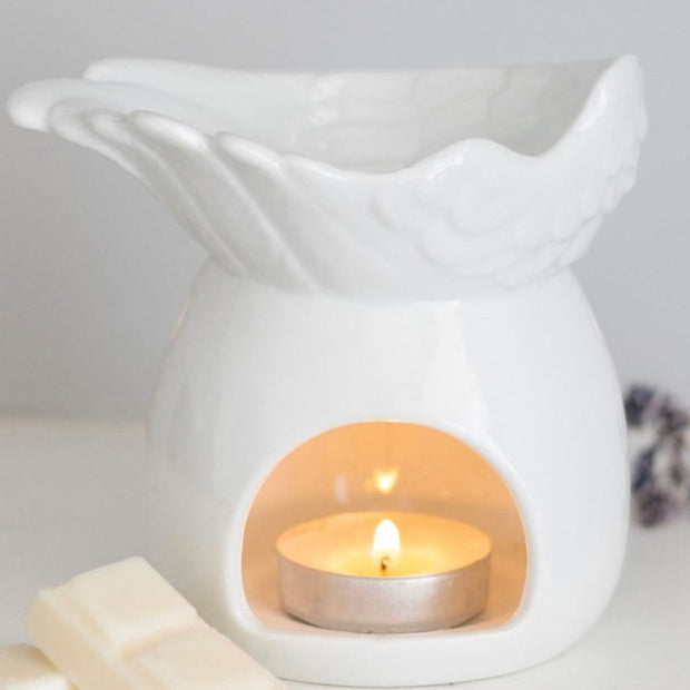 White ceramic angel wings dish wax melt burner for candles and wax melts, featuring a decorative angel wing design.