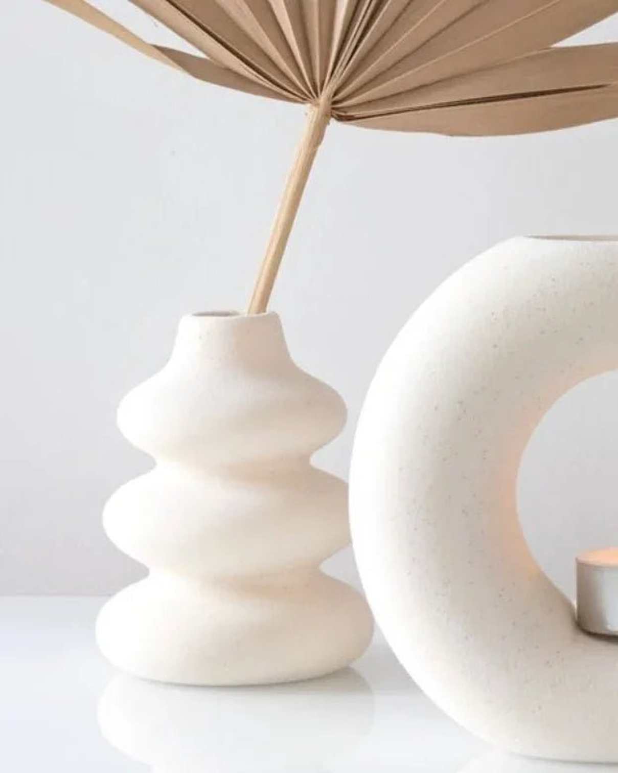 Cream speckle single stem vase used as a wax melt burner, with a smooth, rounded ceramic design and subtle speckle finish.