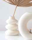 Cream speckle single stem vase used as a wax melt burner, with a smooth, rounded ceramic design and subtle speckle finish.