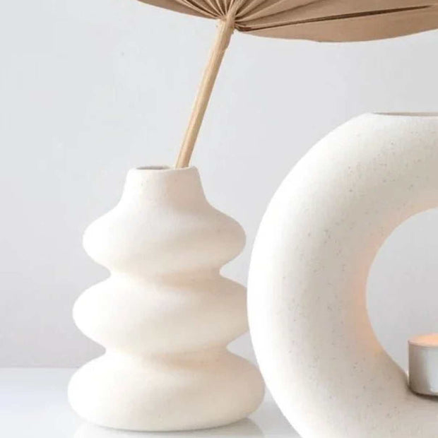 Cream speckle single stem vase used as a wax melt burner, with a smooth, rounded ceramic design and subtle speckle finish.