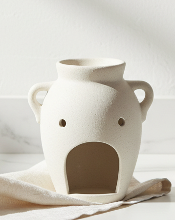 Vase-shaped oil burner and wax warmer from Something Different Wholesale, decorative wax melt burner with a sleek design.