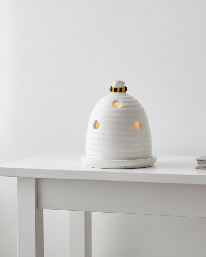 White beehive tealight holder for wax melts, decorative home fragrance burner with intricate hive design.
