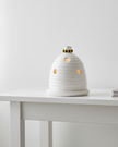 White beehive tealight holder for wax melts, decorative home fragrance burner with intricate hive design.