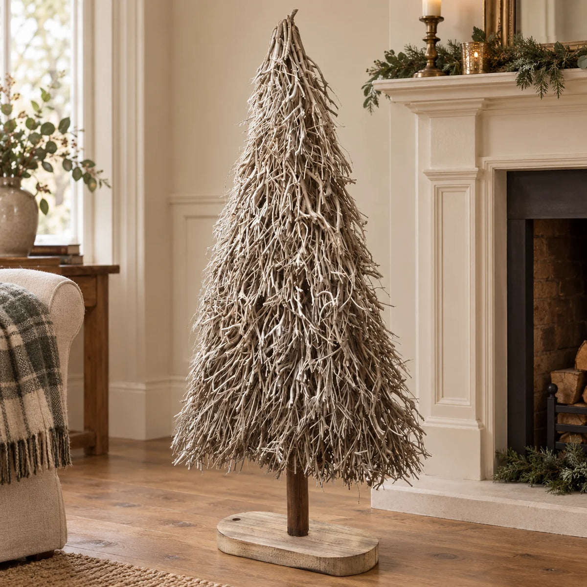 Standing white and natural twig tree beside a cream mantel.