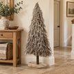 Standing white and natural twig tree in a country hallway.