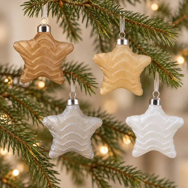 Gold, taupe, silver and white star wave glass baubles on evergreen branches, sold separately