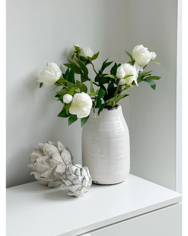 Artificial luxury white double peony flower stem from Starlight Express, showcasing full bloom and lush green leaves.