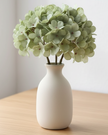 Artificial short sage green hydrangea stem by Starlight Express, with lush green blooms and realistic foliage for decorative floral arrangements.