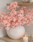 Artificial Soft Peach Blossom Stem from Starlight Express, realistic peach-colored flower branch for home decor or floral arrangements.